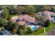 Aerial view of the grand home showcasing a screened pool, meticulously landscaped grounds and a circular driveway at 6126 Kirkstone Ln, Windermere, FL 34786