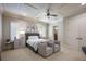 Cozy bedroom with neutral tones, coffered ceiling, two chairs, and ample natural light at 6126 Kirkstone Ln, Windermere, FL 34786
