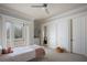 bedroom with a private balcony, plush carpet, and charming decor at 6126 Kirkstone Ln, Windermere, FL 34786