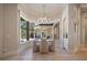 Bright dining room with a chandelier and views of the outdoor living space at 6126 Kirkstone Ln, Windermere, FL 34786