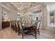 Elegant dining room with a large table and decorative chandelier at 6126 Kirkstone Ln, Windermere, FL 34786