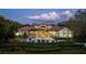 Stunning property at twilight with a beautiful pool, lush landscaping, and inviting outdoor living spaces at 6126 Kirkstone Ln, Windermere, FL 34786