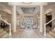 Grand foyer featuring soaring ceilings, columns, light wood floors, and beautiful architectural details at 6126 Kirkstone Ln, Windermere, FL 34786