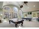 Entertaining game room with pool tables and large windows offering a scenic outdoor view at 6126 Kirkstone Ln, Windermere, FL 34786