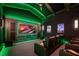 Comfortable home theater with ambient green lighting, theater seating, and a large screen at 6126 Kirkstone Ln, Windermere, FL 34786