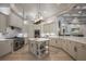 Elegant kitchen with stainless appliances, light cabinetry, marble backsplash and counters, and a center island at 6126 Kirkstone Ln, Windermere, FL 34786