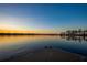 Serene lake view at sunset, with a wooden dock in the foreground at 6126 Kirkstone Ln, Windermere, FL 34786