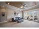 Open living room with couch, piano, balcony access, and scenic lake views at 6126 Kirkstone Ln, Windermere, FL 34786
