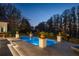 Stunning twilight view of the pool and manicured landscaping at 6126 Kirkstone Ln, Windermere, FL 34786