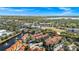 An aerial view of a condo community with a lake and beautiful landscaping in a serene suburban setting at 6157 Metrowest Blvd # 106, Orlando, FL 32835