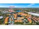 Aerial view of the community, featuring a nearby college, lake, trees, and shopping centers at 6157 Metrowest Blvd # 106, Orlando, FL 32835