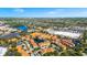 Aerial view of the apartment complex with beautiful ponds, landscaping, and a view of the city skyline at 6157 Metrowest Blvd # 106, Orlando, FL 32835