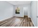 Bright bedroom featuring hardwood floors, a ceiling fan and a large window at 6157 Metrowest Blvd # 106, Orlando, FL 32835