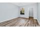 Bright bedroom featuring hardwood floors, a ceiling fan and a large window at 6157 Metrowest Blvd # 106, Orlando, FL 32835