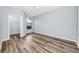 This bedroom features a large window, wood-look flooring, a ceiling fan, and a walk-in closet at 6157 Metrowest Blvd # 106, Orlando, FL 32835