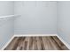 A walk-in closet with wood-look flooring, white wire shelving and white trim at 6157 Metrowest Blvd # 106, Orlando, FL 32835