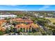 Exterior view showcasing a condo building in a well-maintained community, surrounded by lush landscaping and ample parking at 6157 Metrowest Blvd # 106, Orlando, FL 32835