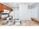 Well-lit kitchen with stainless steel sink, white appliances, and warm wood cabinets at 6157 Metrowest Blvd # 106, Orlando, FL 32835