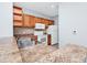 Well-lit kitchen with stainless steel sink, white appliances, and warm wood cabinets at 6157 Metrowest Blvd # 106, Orlando, FL 32835