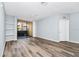 This living room features modern wood floors, neutral paint, a ceiling fan, and sliding doors to a screened balcony at 6157 Metrowest Blvd # 106, Orlando, FL 32835