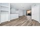 Spacious living room featuring an open layout with modern floors, neutral walls, and sliding doors to a screened balcony at 6157 Metrowest Blvd # 106, Orlando, FL 32835