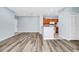 View of the spacious living room featuring modern flooring, neutral paint, and seamless transition to the kitchen area at 6157 Metrowest Blvd # 106, Orlando, FL 32835