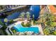 Overhead view of a pool with fountains, surrounded by palm trees and well-maintained landscaping, creating a resort-like ambiance at 6157 Metrowest Blvd # 106, Orlando, FL 32835