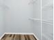 Walk-in closet with hardwood floors and metal shelving at 6157 Metrowest Blvd # 106, Orlando, FL 32835