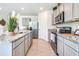 Modern kitchen featuring stainless steel appliances, gray cabinets, and granite countertops at 7076 Painted Bunting Way, St Cloud, FL 34773