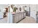 Modern kitchen featuring stainless steel appliances, an island, and a seamless connection to living spaces at 7076 Painted Bunting Way, St Cloud, FL 34773