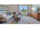 Comfortable living room with modern sofa, sleek wooden cabinet, and picturesque window views at 7083 Painted Bunting Way, St Cloud, FL 34773