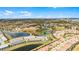 Stunning aerial view of a community featuring beautiful homes, serene lakes, and lush landscaping under a bright, clear sky at 7509 Oak Spring Ln, Davenport, FL 33837