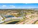 Stunning aerial view of a community featuring beautiful homes, serene lakes, and lush landscaping under a bright, clear sky at 7509 Oak Spring Ln, Davenport, FL 33837