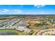 Aerial view of the neighborhood featuring homes nestled around lakes, offering a peaceful and scenic living environment at 7509 Oak Spring Ln, Davenport, FL 33837