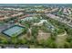 Community aerial view showcasing the pool, lazy river, tennis courts, and neighborhood homes at 7509 Oak Spring Ln, Davenport, FL 33837