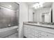 Elegant bathroom featuring double vanity with granite countertop and tiled shower/tub combination at 7509 Oak Spring Ln, Davenport, FL 33837