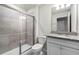Well-lit bathroom featuring a shower, toilet, and vanity with granite countertop at 7509 Oak Spring Ln, Davenport, FL 33837