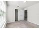 Inviting bedroom with neutral carpet, bright windows, and closet space at 7509 Oak Spring Ln, Davenport, FL 33837