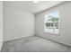 Neutral bedroom with carpet floors, a window overlooking a palm tree, and ample natural light at 7509 Oak Spring Ln, Davenport, FL 33837