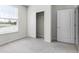 Bright bedroom with closet, ensuite access, and a window view at 7509 Oak Spring Ln, Davenport, FL 33837