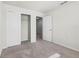Bedroom featuring a closet, neutral carpet, and two doorways at 7509 Oak Spring Ln, Davenport, FL 33837