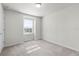 Bright bedroom with carpet, a window offering natural light, and neutral decor at 7509 Oak Spring Ln, Davenport, FL 33837