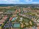 Aerial view of the community amenities, showcasing a large pool area, tennis courts, and beautifully landscaped grounds at 7509 Oak Spring Ln, Davenport, FL 33837