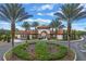 Elegant community entrance featuring lush landscaping and a stylish archway, creating a welcoming first impression at 7509 Oak Spring Ln, Davenport, FL 33837