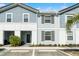 Charming two-story townhome with light blue siding and neat landscaping offers a welcoming curb appeal at 7509 Oak Spring Ln, Davenport, FL 33837