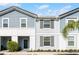 Charming townhome with a covered entryway and manicured landscaping at 7509 Oak Spring Ln, Davenport, FL 33837