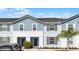 Charming townhome featuring a well-maintained front yard and inviting entryways, perfect for a comfortable and stylish living at 7509 Oak Spring Ln, Davenport, FL 33837