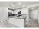 Modern kitchen featuring white cabinetry, granite countertops, a center island and stainless steel appliances at 7509 Oak Spring Ln, Davenport, FL 33837