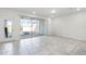 Bright living area with tile flooring, sliding glass doors with pool views, and neutral walls at 7509 Oak Spring Ln, Davenport, FL 33837