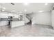 Open concept kitchen and living room with ceramic tile flooring, pendant lighting, and a staircase at 7509 Oak Spring Ln, Davenport, FL 33837